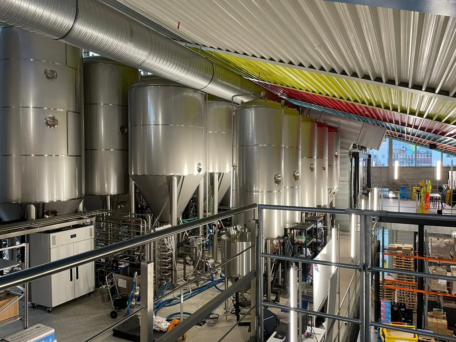 Interior of a high-volume brewing facility, including tanks and equipment